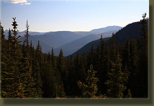 Evening descends across miles of forested mountains